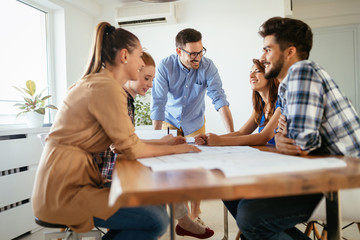 Group of young business people and architects working on project