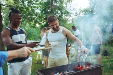 Group of friends making barbecue in the backyard. concept about good and positive mood with friends