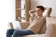 © Pixel-Shot - Young freelancer with laptop relaxing on sofa at home