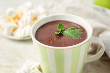 Cup of hot chocolate on table, closeup