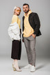 © LIGHTFIELD STUDIOS - young couple of models in stylish autumn outfits posing on grey background