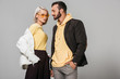 © LIGHTFIELD STUDIOS - stylish couple of models in autumn outfits posing isolated on grey background