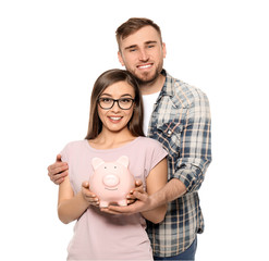 Happy couple holding piggy bank on white background. Money savings concept