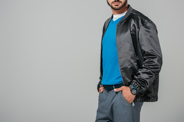 Wall Mural - cropped image of man in stylish outfit posing with hands in pockets isolated on grey background