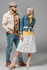 Poster - couple posing in autumn outfit and looking at each other, on grey