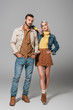 © LIGHTFIELD STUDIOS - couple of models posing in street style autumn outfit, on grey
