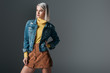 © LIGHTFIELD STUDIOS - attractive woman posing in yellow turtleneck, trendy corduroy skirt and jeans jacket, isolated on grey