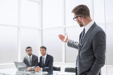 businessman pointing to his office