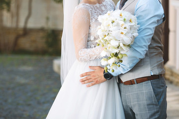 Wall Mural - Groom Hugging Bride with Bouquet