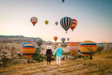 Happy Young Couple During Sunrise Watching The Hot Air Balloons Of Kapadokya Cappadocia Turkey