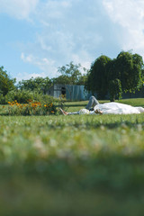 Wall Mural - Relaxing Bride and Groom on Grass