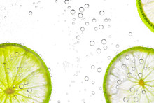 Close Up Fresh Lime Sliced In Soda Or Water Bubbles, Isolated On White Background