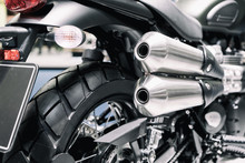 Close Up Shot Of New Motorcycle Exhaust Pipes. Rear View Of A Motorcycle With The Focus On The Chrome Exhaust.