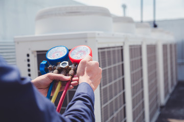 Wall Mural - Technician is checking air conditioner ,measuring equipment for filling air conditioners.