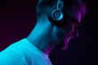 © monchak - Neon portrait of bearded smiling man in headphones, sunglasses, white t-shirt. Listening to music