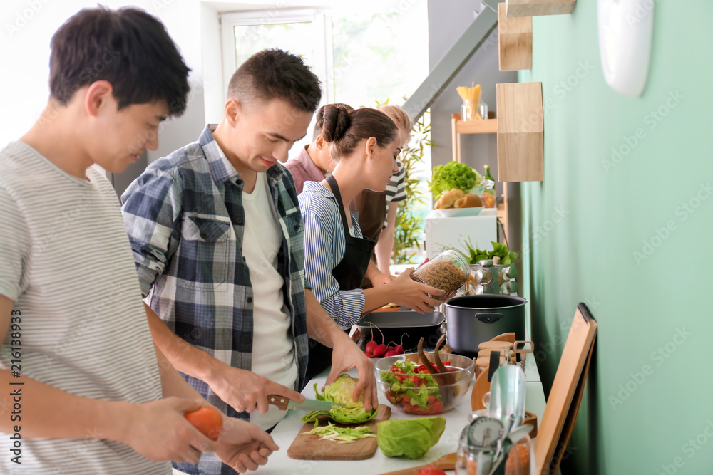 Friends cooking together in kitchen
