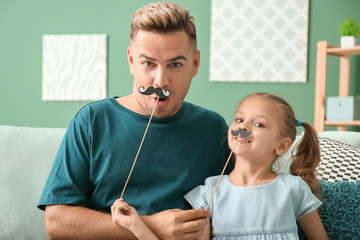 Wall Mural - Happy father and daughter playing with party decor at home