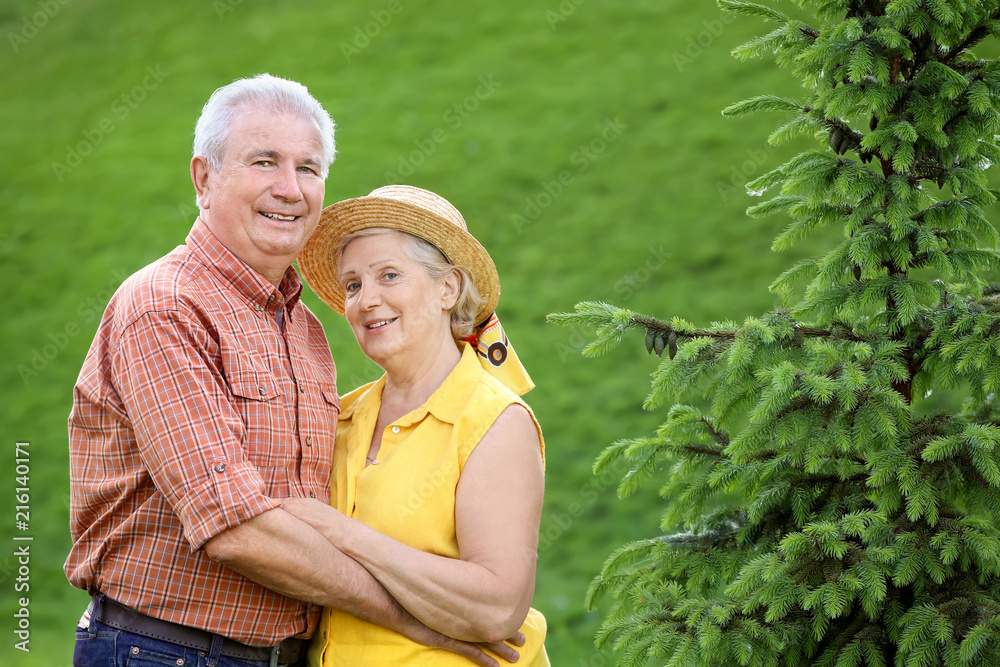 Happy mature couple in city park