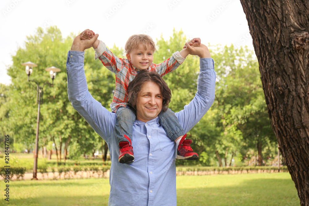 Happy father with son in green park