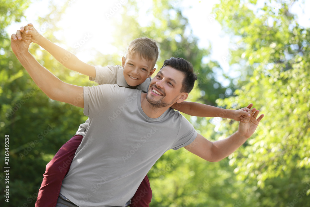 Happy man with his little son in park
