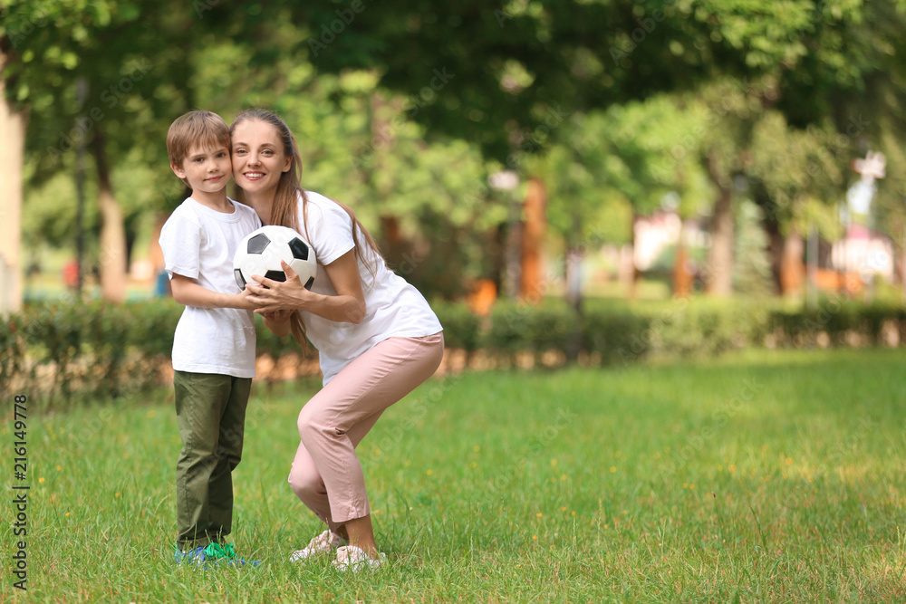 Happy mother and son in park on summer day
