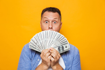 Emotional handsome man holding money.