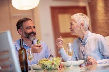 Wall Mural - Mature couple having lunch together at home