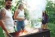 © master1305 - Group of friends making barbecue in the backyard. concept about good and positive mood with friends