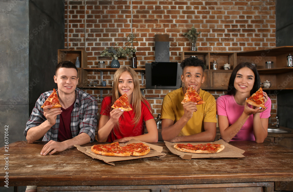 Young people eating delicious pizza indoors