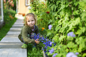 little and happy girl on flowers background