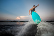 © fesenko - Athletic and strong man jumping on wakesurf down the river waves at the sunset