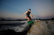 © fesenko - Handsome athletic man riding on wakesurf down the river during sunset