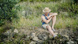 © starsstudio - Attractive, fit young man relaxing sitting in a grass field, wearing straw hat