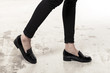 © dohee - woman wearing black enamel shoes isolated white.