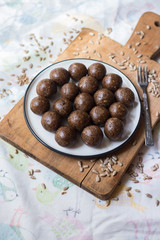 Wall Mural - Raw vegan sweet balls with dates, coconut, cocoa powder, cocoa butter, banana and nuts. Vegetarian truffel dessert with carob powder.