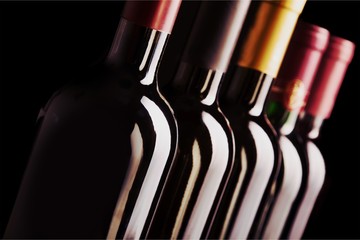 Canvas Print - Dark wine bottles in row