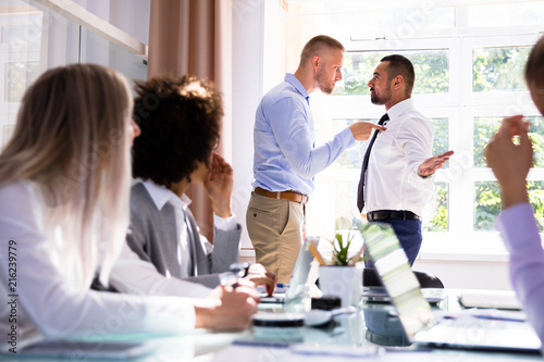 Two Male Colleagues Fighting In Office Tableau sur Toile