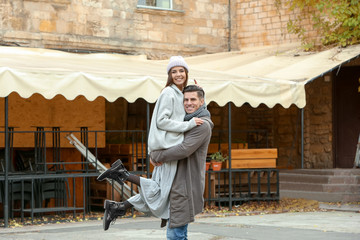 Sticker - Beautiful couple in warm clothes on city street