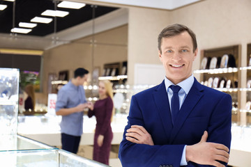 Portrait of young man in jewelry store. Small business owner