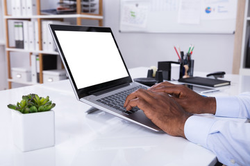 Close-up Of Man Using Laptop