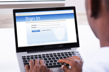 Businessman Signing In The Website On Laptop