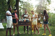 © master1305 - Group of friends making barbecue in the backyard. concept about good and positive mood with friends