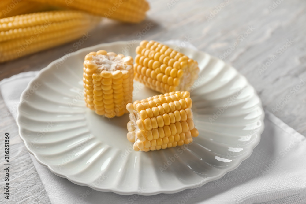 Fresh cut corn cob on plate