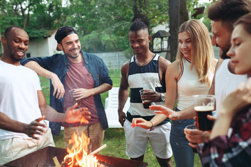 Wall Mural - Group of friends making barbecue in the backyard. concept about good and positive mood with friends