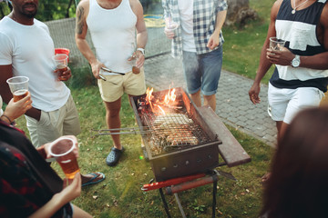 Wall Mural - Group of friends making barbecue in the backyard. concept about good and positive mood with friends