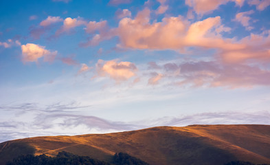 Wall Mural - reddish cloudscape over the mountain top. beautiful nature background at sunset