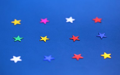 Flat lay of star decorations closeup on blue texture blur background