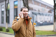 © Africa Studio - Young man in warm clothes talking on cell phone outdoors