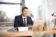 © Africa Studio - Young man in elegant suit at workplace