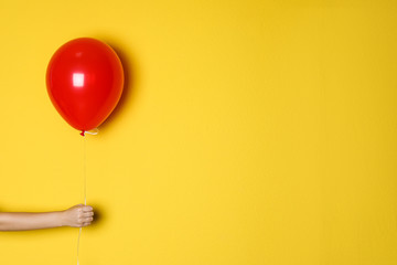 Sticker - Woman holding red balloon on color background